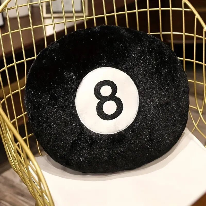 Black 8 ball throw pillow on a modern sofa in a game room