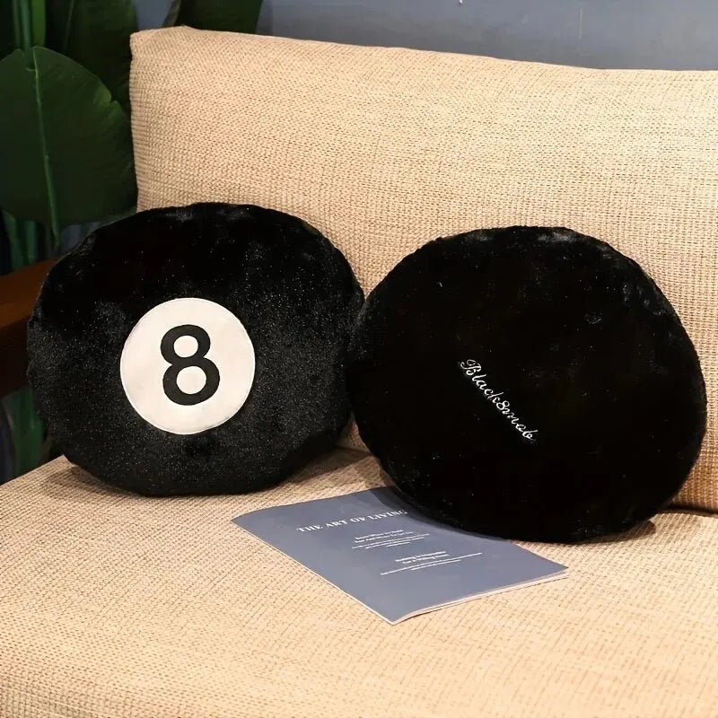 Black 8 ball throw pillow on a modern sofa in a game room