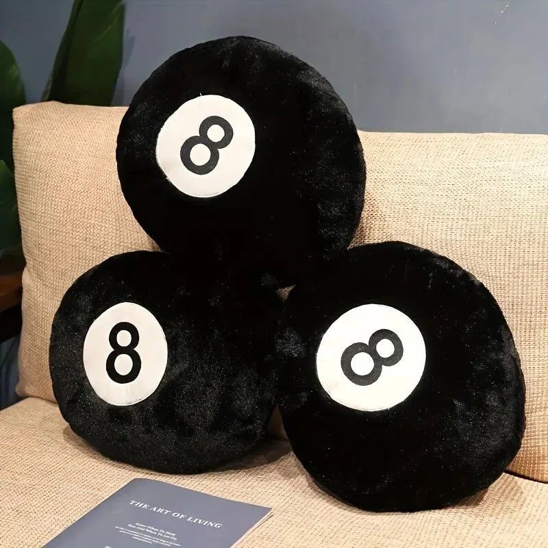 Black 8 ball throw pillow on a modern sofa in a game room
