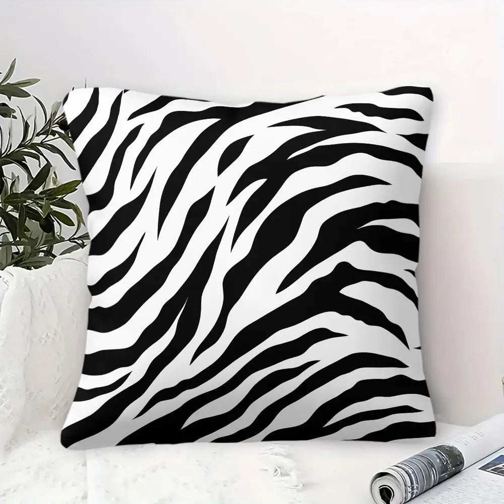 Black and white zebra print throw pillow on a modern sofa