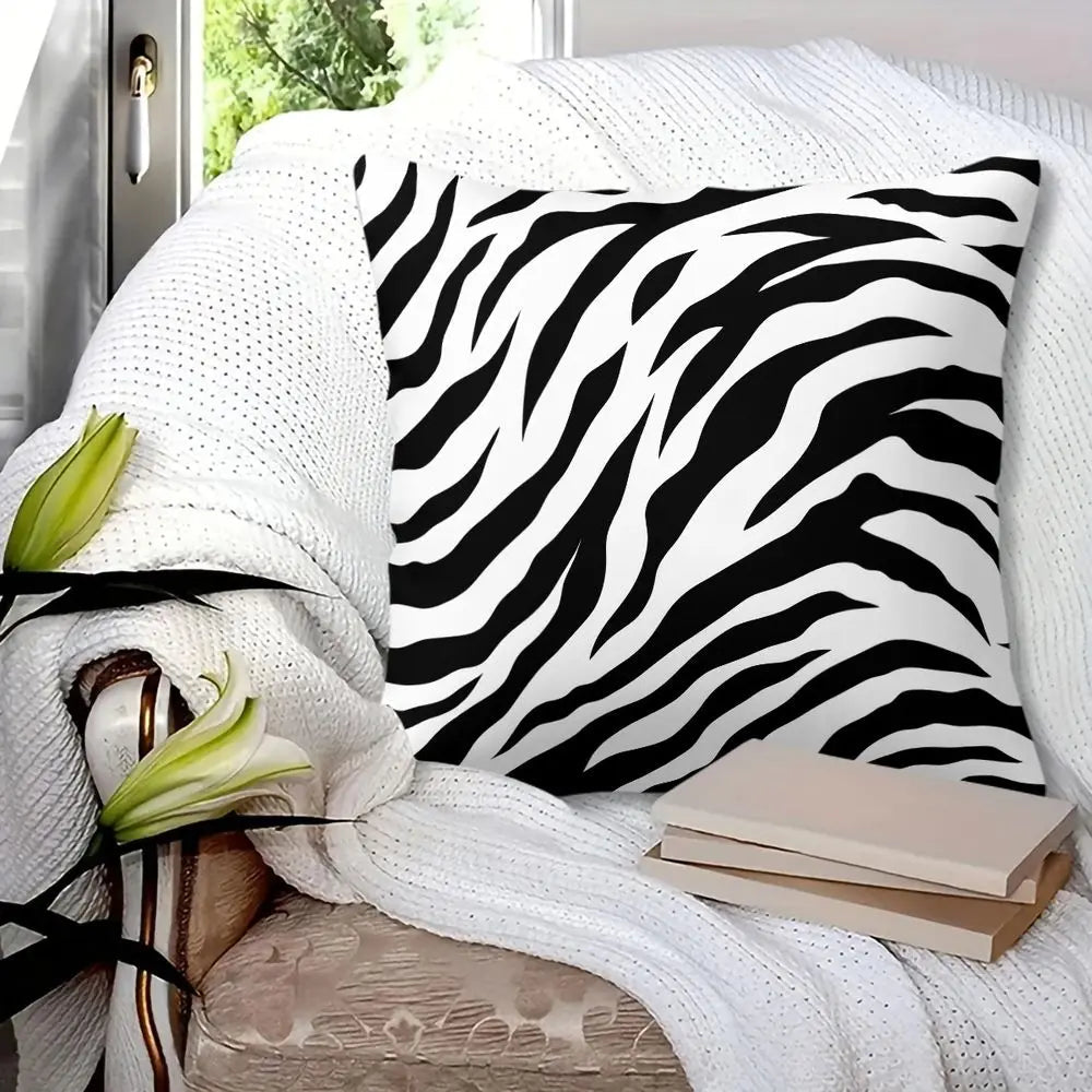 Black and white zebra print throw pillow on a modern sofa