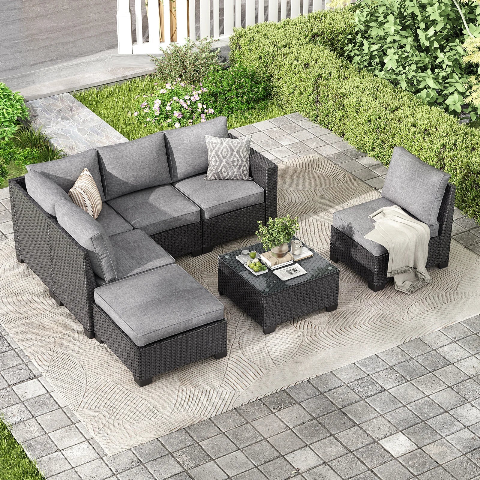 Farini outdoor patio sectional sofa set with gray wicker, dark gray water-resistant cushions, and matching ottoman