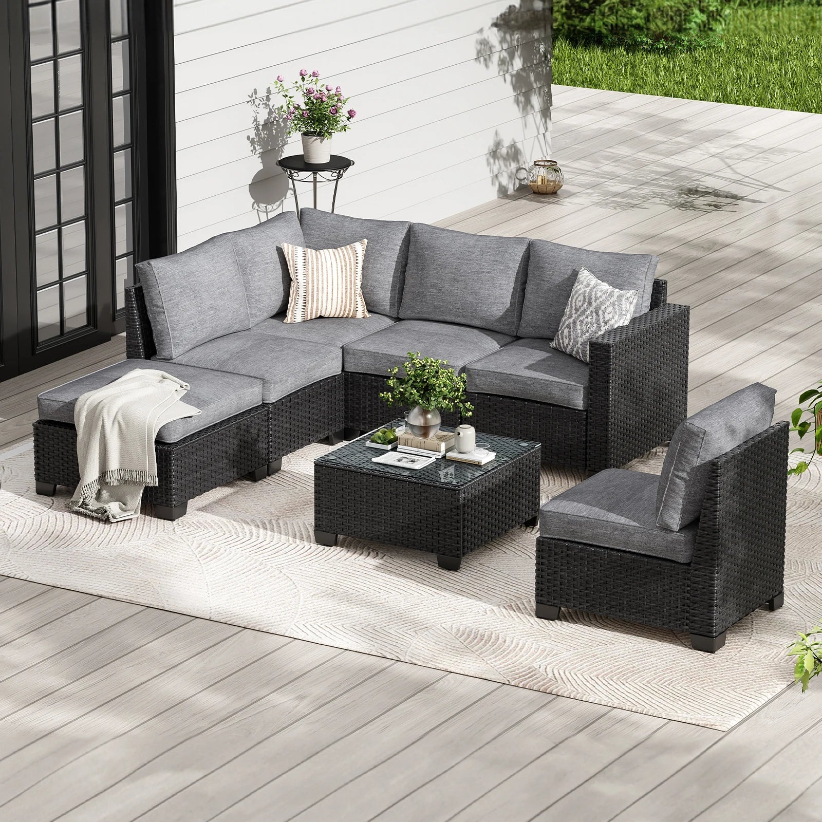 Farini outdoor patio sectional sofa set with gray wicker, dark gray water-resistant cushions, and matching ottoman