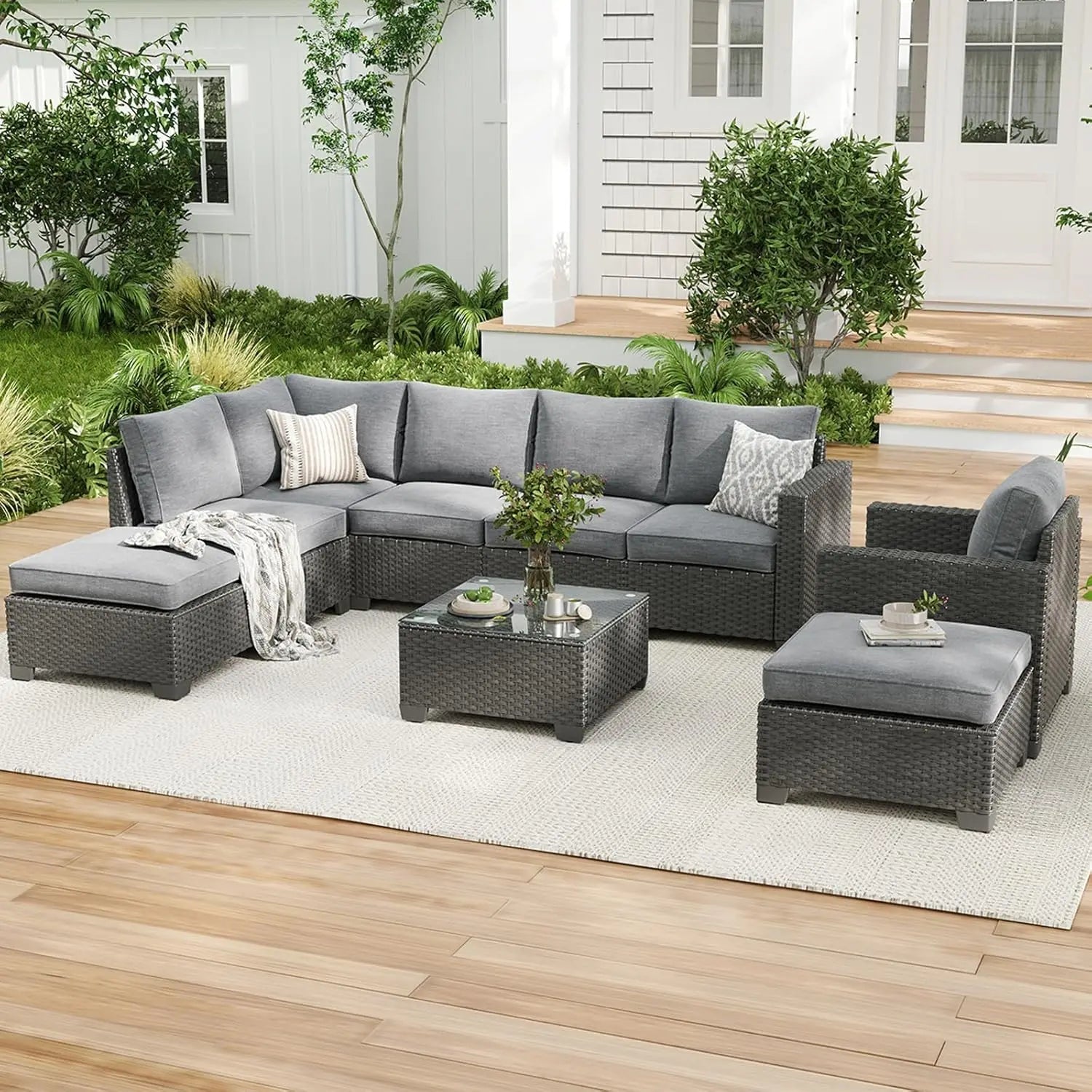 Farini outdoor patio sectional sofa set with gray wicker, dark gray water-resistant cushions, and matching ottoman