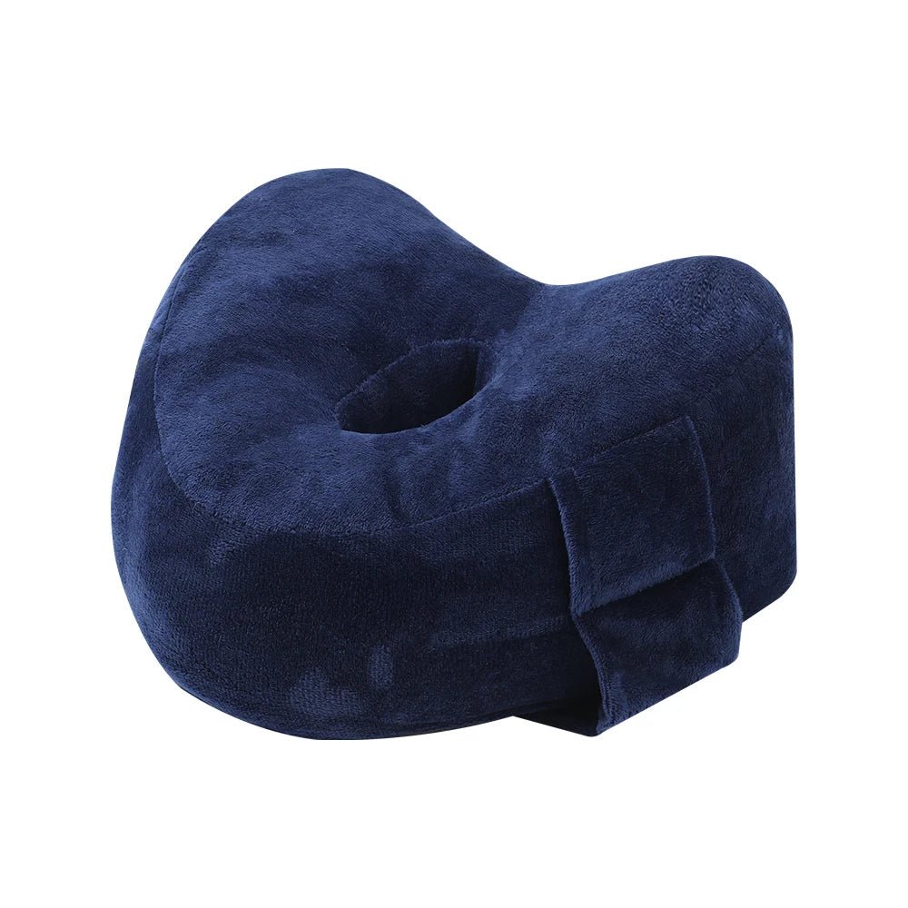 Memory foam orthopedic knee pillow placed between the legs of a side sleeper