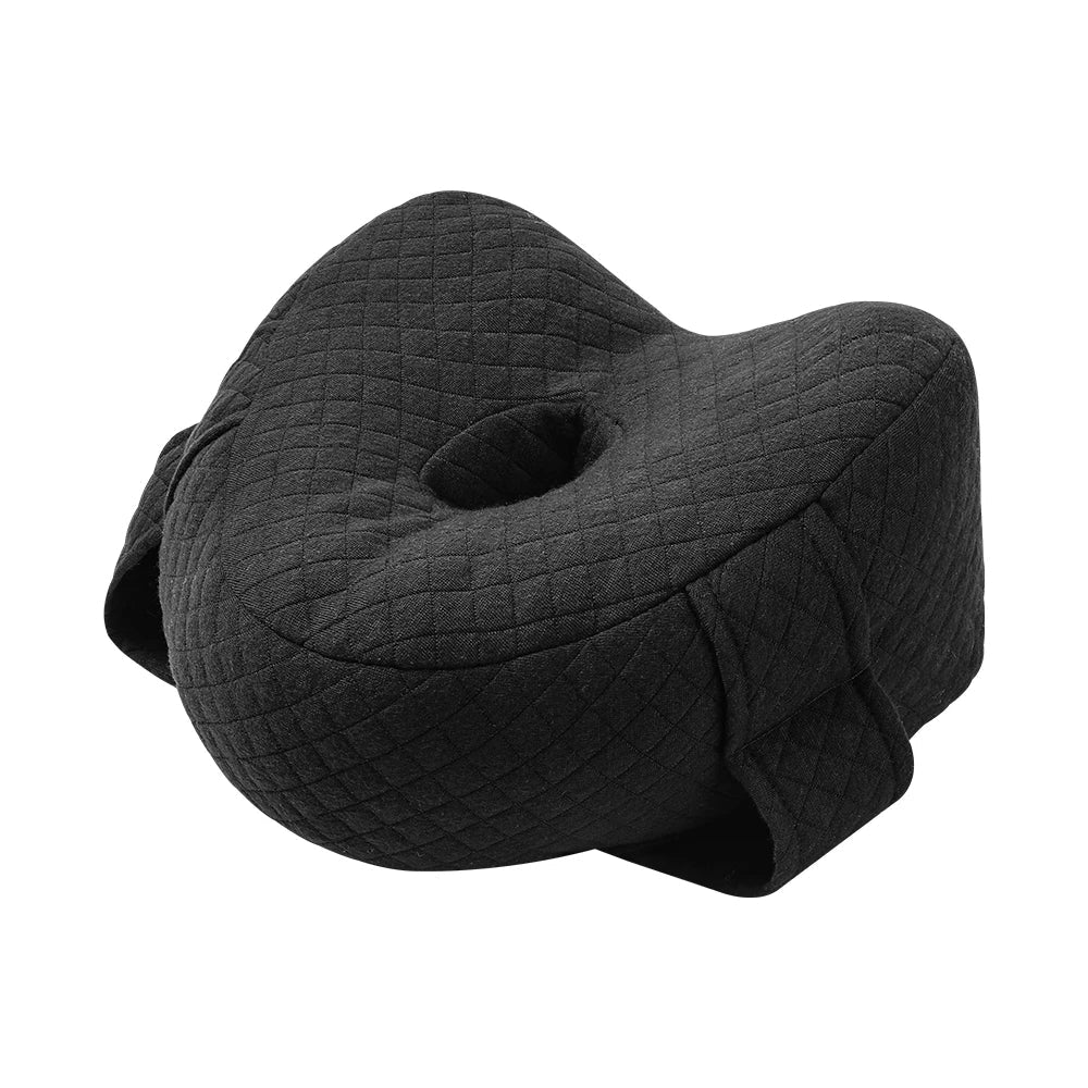 Memory foam orthopedic knee pillow placed between the legs of a side sleeper