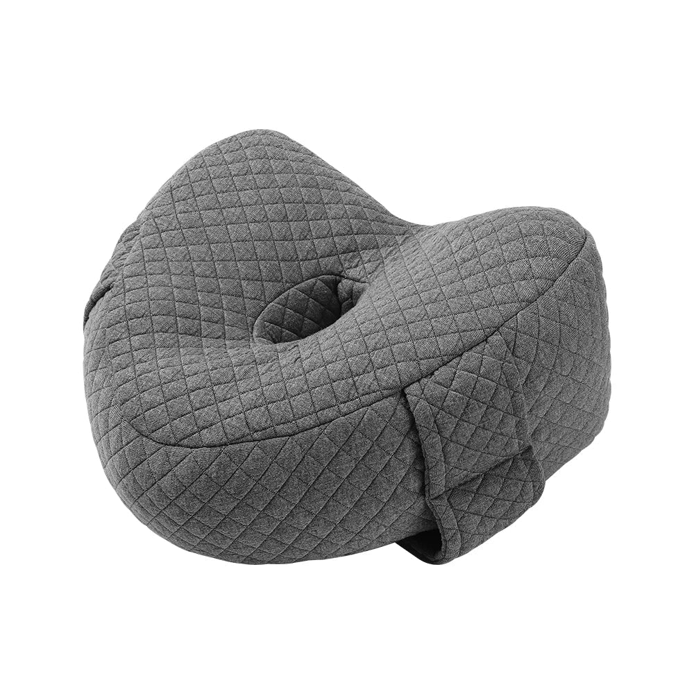 Memory foam orthopedic knee pillow placed between the legs of a side sleeper