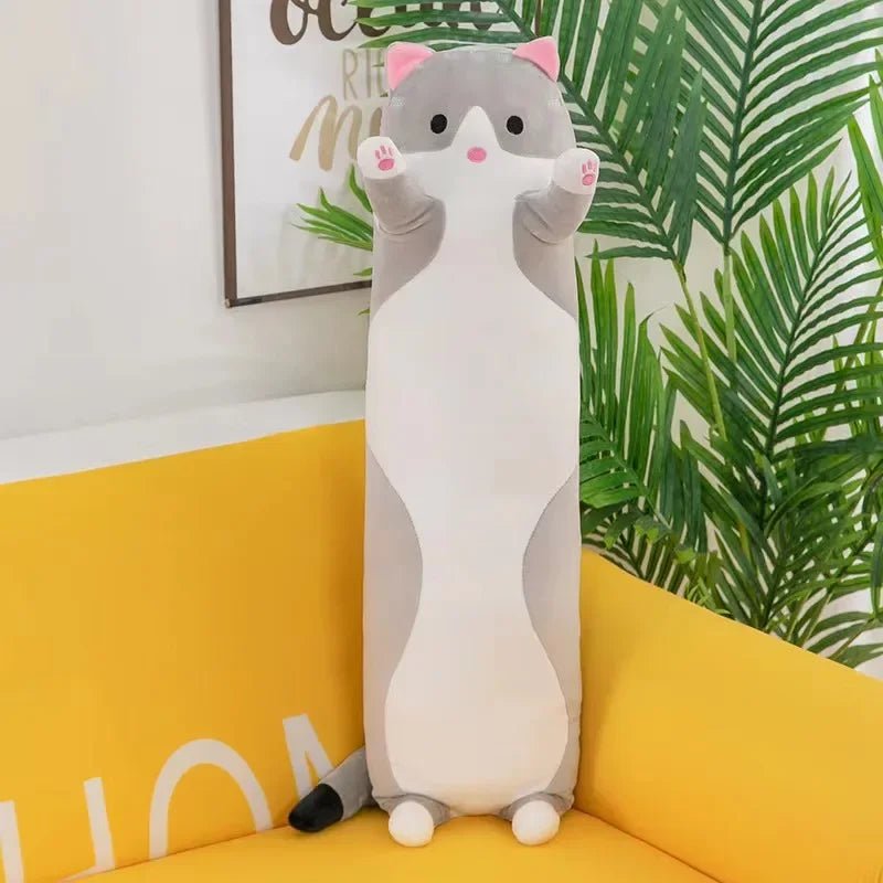 Long cat plush body pillow on a bed for cuddling and bedroom décor