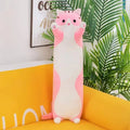 Long cat plush body pillow on a bed for cuddling and bedroom décor