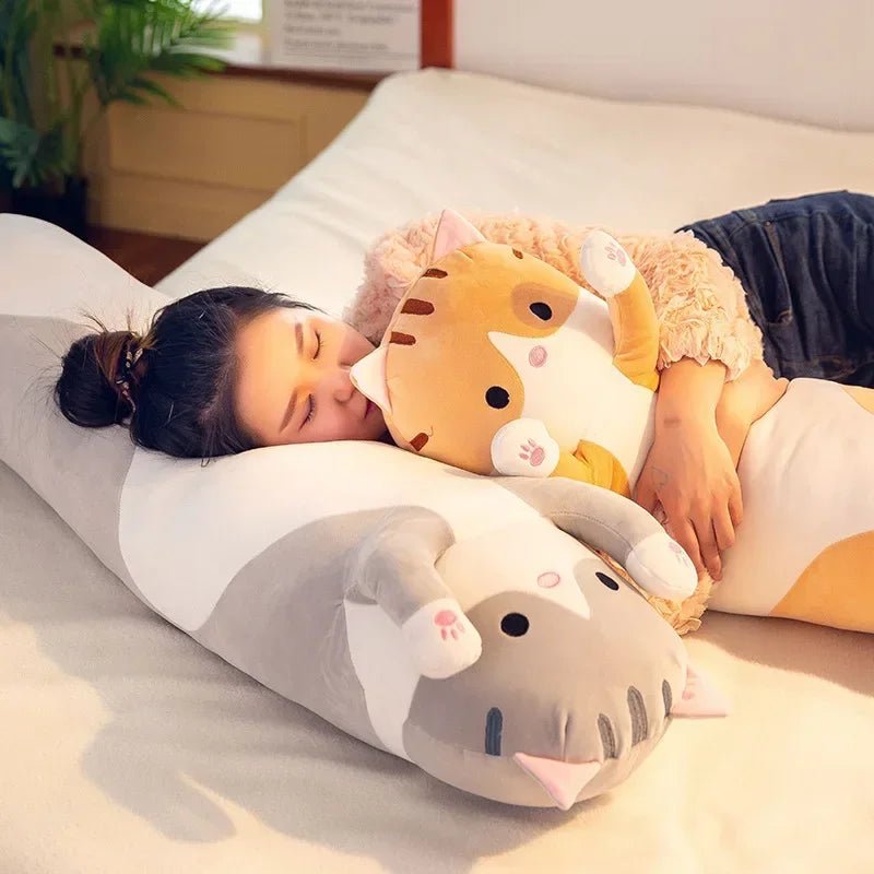 Long cat plush body pillow on a bed for cuddling and bedroom décor
