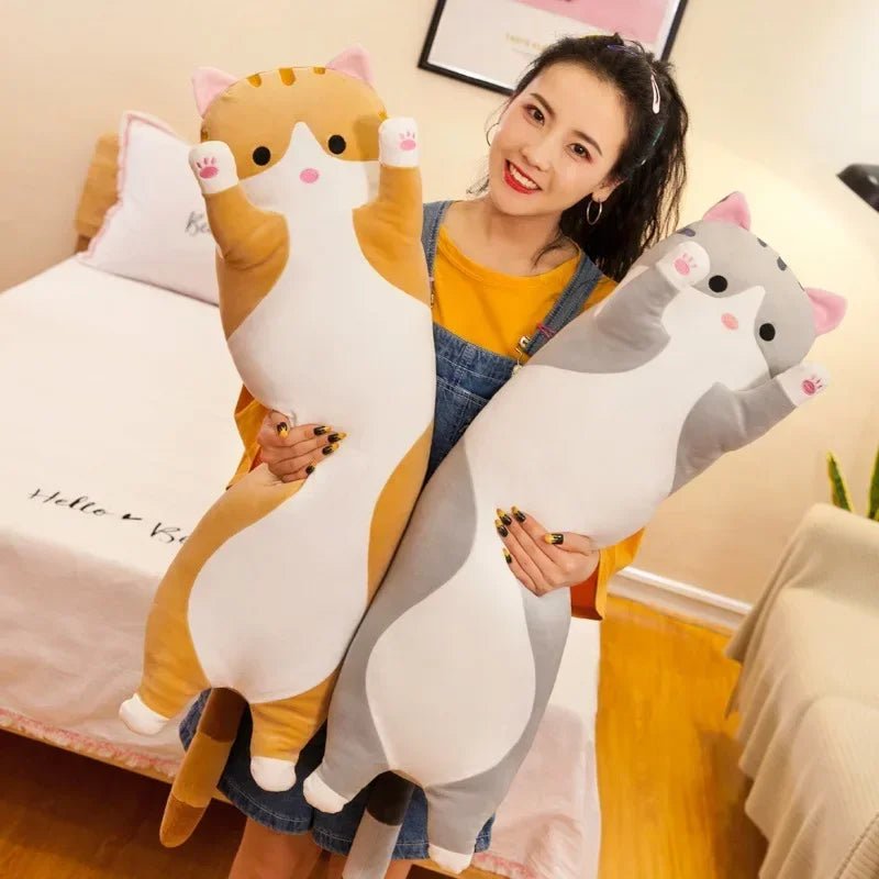 Long cat plush body pillow on a bed for cuddling and bedroom décor