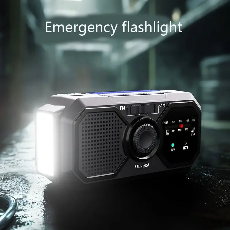 Portable emergency solar radio with hand crank, solar charging, AM/FM weather radio, LED flashlight, and USB phone charger.